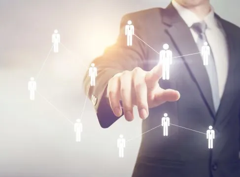 Businessman touching on screen managing group people icons. HR concept