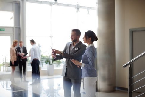 Business people checking datas in lobby