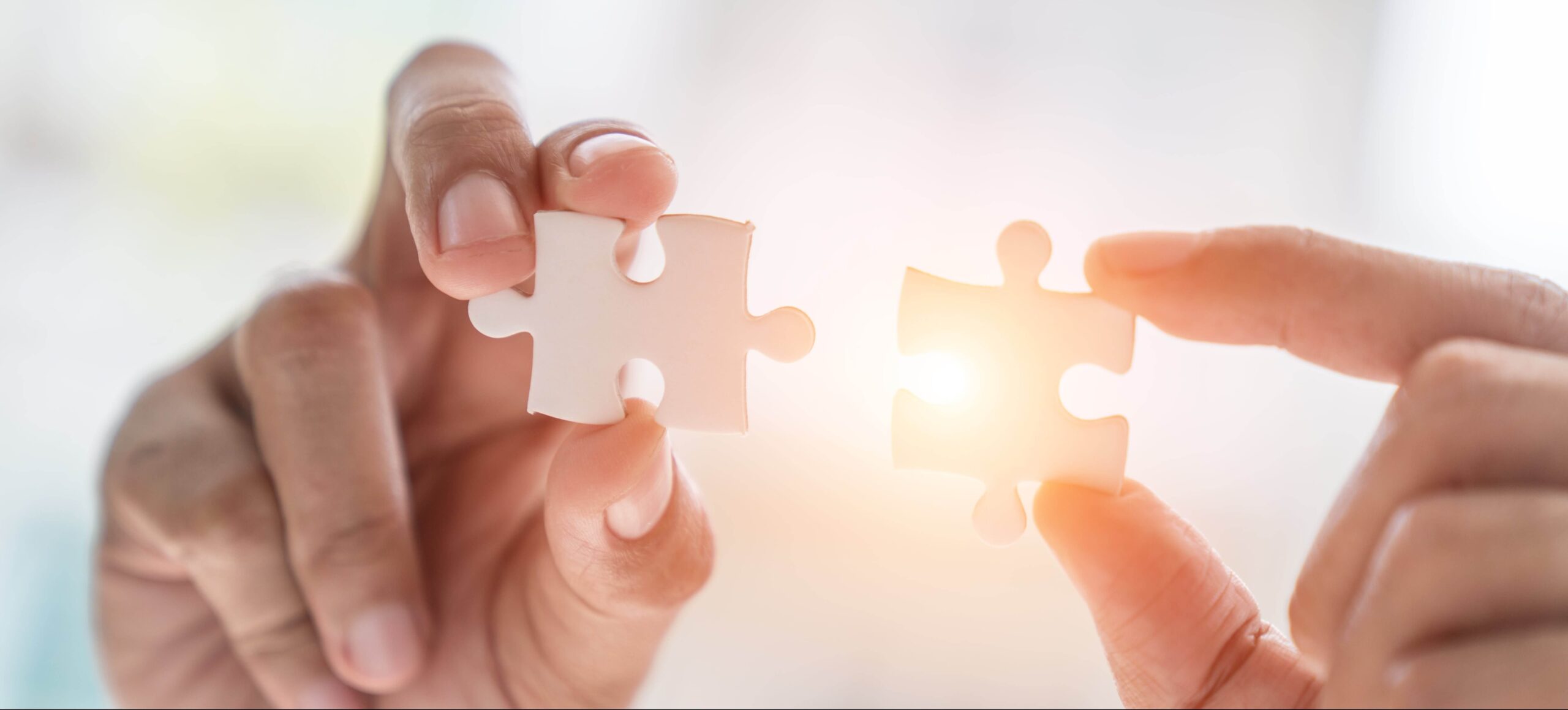 Business solutions, success and strategy concept. Businessman hand connecting jigsaw puzzle.