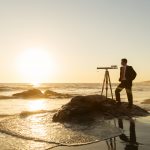Businessman with Telescope on California Beach