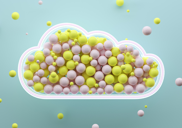 Digital generated image of yellow and pink spheres inside glowing cloud shape on blue background.