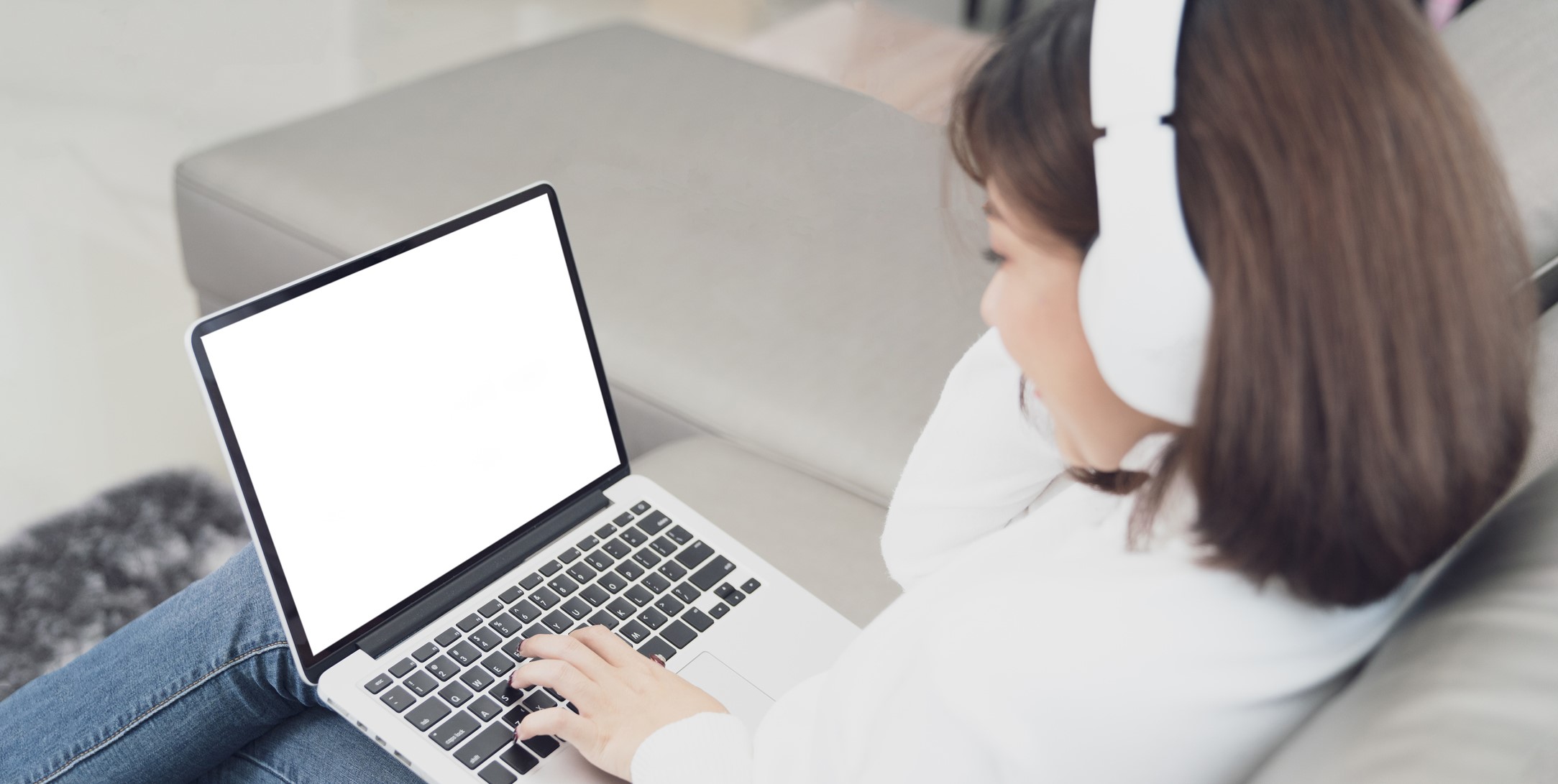 Happy young woman in headphones speaking looking at laptop making notes. Girl student talking by video conference call. Female teacher trainer tutoring by webcam. Online training. E-coaching concept