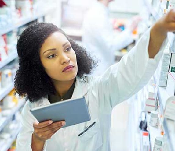 Pharmacist checking prescription inventory