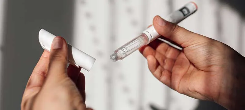 Semaglutide injection pen or cartridge pen for diabetics and weight loss in female hand. Medical equipment for diabetes patients