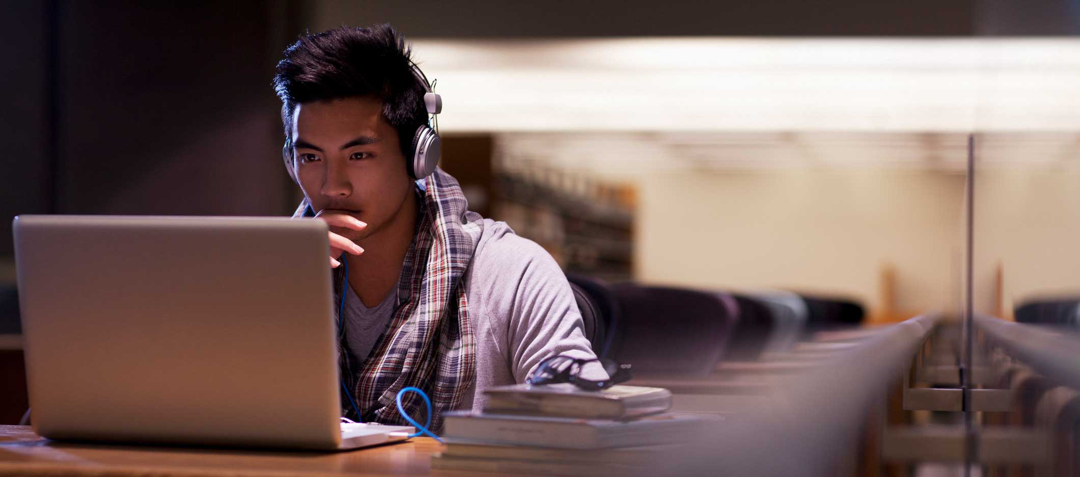 Student working on laptop in library
