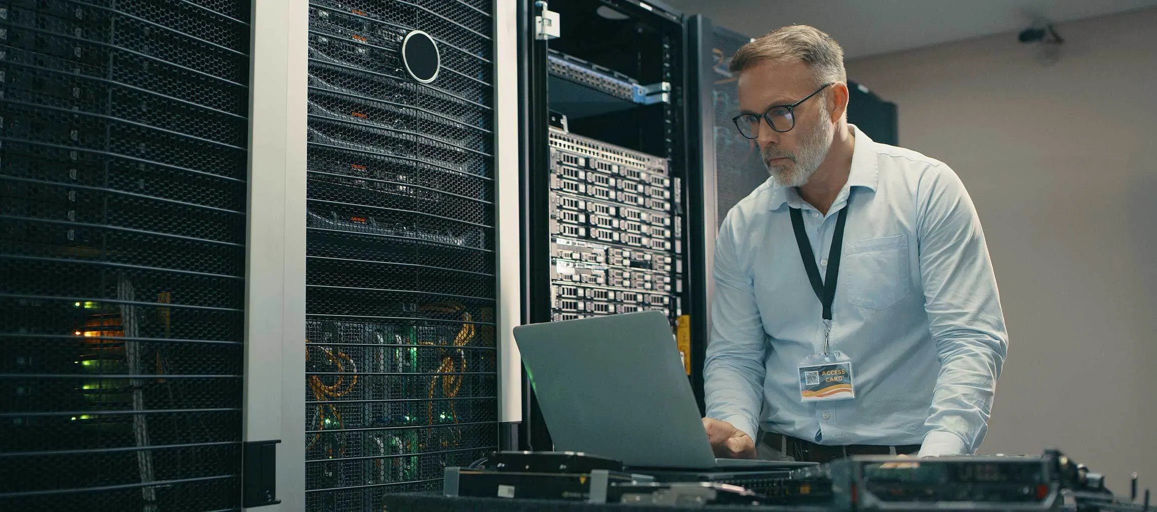 Shot of a mature man using a laptop while working in a data centre